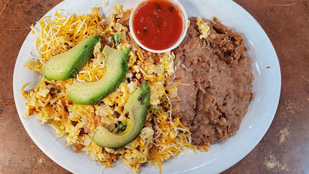 Migas · Eggs scrambled with onions, tomatoes, tortilla strips, and jalapenos.