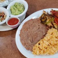 Chicken Fajitas (1/2 Lb.) · Served with rice, beans, tortillas, guacamole, and pico de gallo. Cooked with peppers and on...