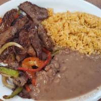 Steak Fajitas (1/2 Lb.) · Served with rice, beans, tortillas, guacamole, and pico de gallo. Cooked with peppers and on...