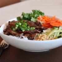 Grilled Pork Vermicelli · Vermicelli served with fresh lettuce, cucumber, and bean sprouts. Topped with roasted peanut...
