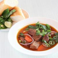 Beef Stew - Bo Kho · Tasty beef broth, carrots, green onion, cilantro, and red onion. Served with bread, rice, ve...