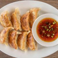 Fried Dumplings (8) · Homemade dumplings filled with pork and vegetables, pan fried until golden brown. Served wit...
