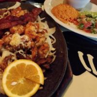 Pepe’S Special · Chicken and beef fajitas sauteed  with bacon, small shrimp, and mushrooms. Covered with Mont...