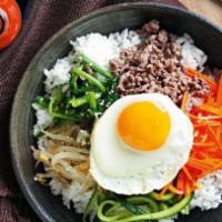 Chicken Bibimbap · Grilled chicken over rice with shredded carrots, bean sprouts, and shiitake mushrooms in a t...
