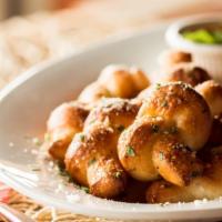 Homemade Garlic Knots · Hand-knotted pizza dough tossed with Sicilian extra virgin olive oil, fresh garlic, and Roma...
