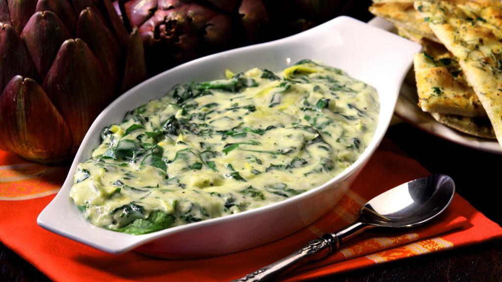 Spinach & Artichoke Dip · Spinach & artichokes blended with five cheeses & served with a seasoned garlic flatbread baked fresh per order.