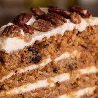 Carrot Cake · Studded with raisins, walnuts, and pineapple, finished with a smooth cream cheese icing.