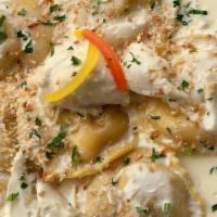 Mama Sonia’S Ravioli Pasta · Homemade pasta stuffed with chicken and porcini mushroom in a white wine cream sauce topped ...