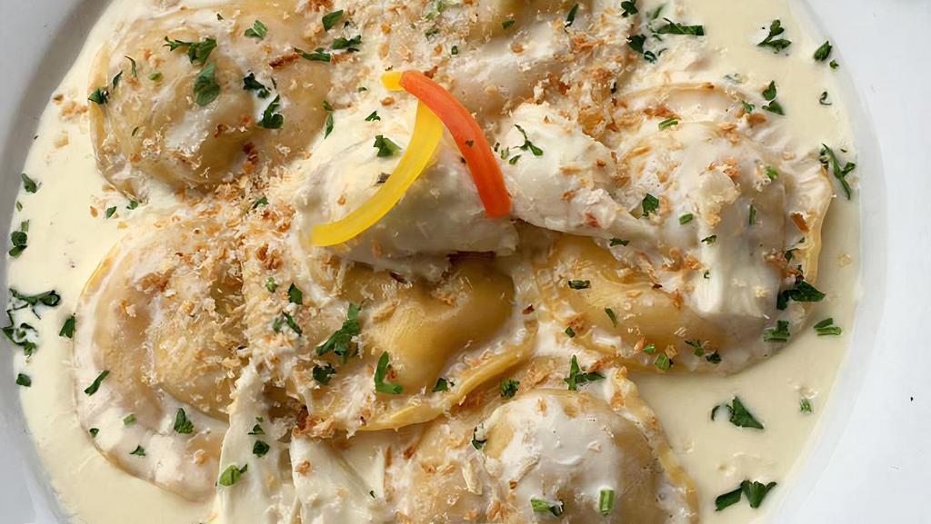 Mama Sonia’S Ravioli Pasta · Homemade pasta stuffed with chicken and porcini mushroom in a white wine cream sauce topped with jumbo lump crab meat.