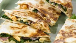 Spinach Chicken Quesadillas · One quesadilla filled with chicken, cheese, spinach, bell peppers, and onions.
