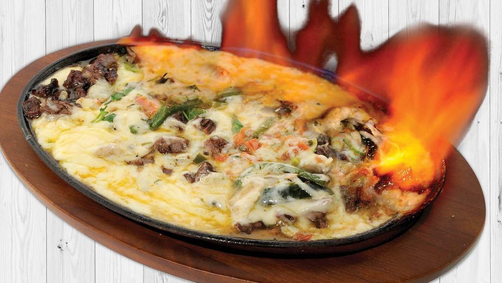 Queso Flameado · Melted cheese with your choice of chorizo (Mexican sausage), chicken, beef, or shrimp. With sautéed red onions and poblano peppers.