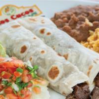Fajita Tacos · (2) large flour tortillas filled with your choice of beef or chicken fajitas, served with ri...