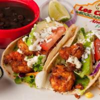 Sriracha Tacos · Gulf shrimp marinated in sriracha and spices, in home-made corn tortillas. Served with lettu...