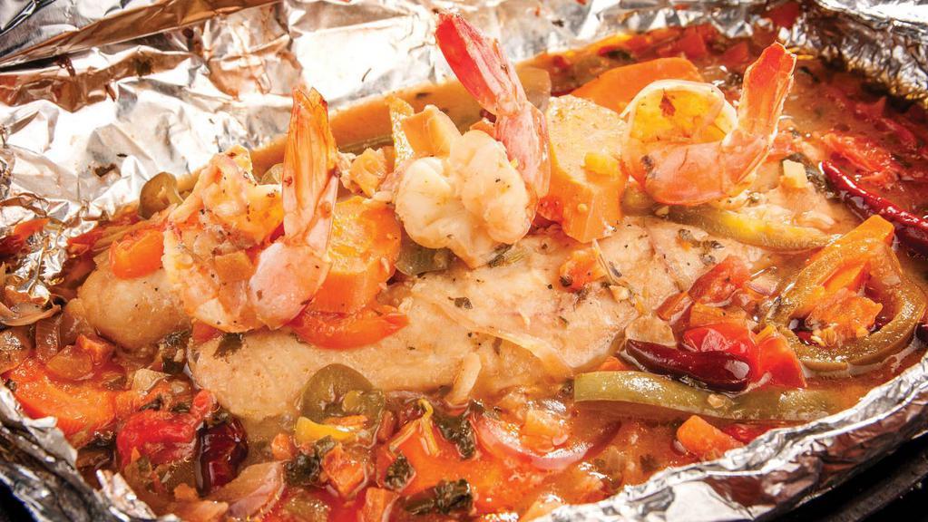 Seafood Al Vapor · 8 oz. fresh fish fillet and (3) jumbo shrimp wrapped in aluminum foil, with spices, tomatoes, peppers, mushrooms, cilantro, and lemon butter sauce.