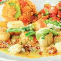 Fish Cancún · 10 oz. fresh bass fillet, sautéed in butter sauce, garlic, and cilantro. Topped with crab me...