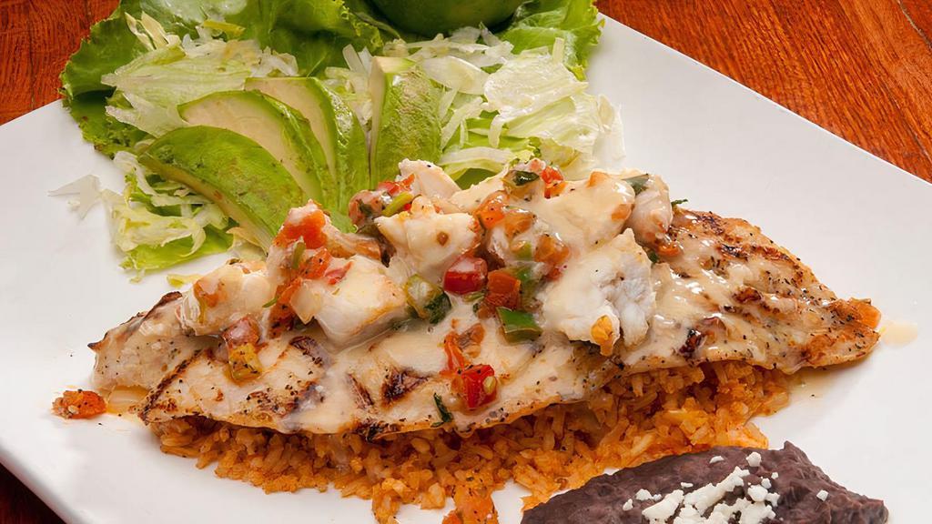 Fish Playa Azul · Grilled bass fish fillet, served on a bed of rice and topped with crab meat, lemon butter sauce, and pico de gallo. Served with sliced avocado and black beans. Substitute fish for tilapia or salmon for an additional charge.