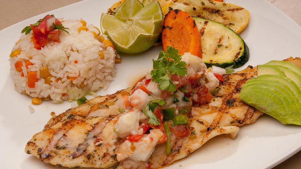 Grilled Fish Fillet · Fish fillet lightly seasoned and grilled, topped with sautéed crab meat. Served with grilled vegetables, white rice, and sliced avocado.