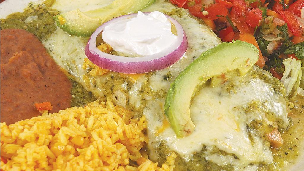 Verdes Enchiladas · (2) chicken fajita enchiladas covered with tomatillo sauce, sour cream, onions, and avocados. Served with rice and refried beans.