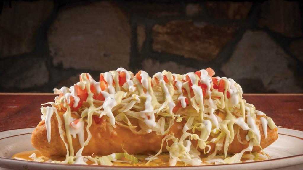 Fajita Chimichanga · Large flour tortilla filled with your choice of beef or chicken fajita, deep-fried, and topped with lettuce, chile con queso, tomato, and sour cream.