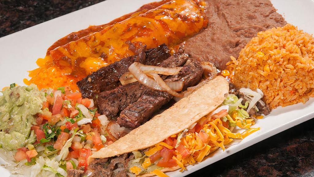 El Gringo · Beef or chicken fajitas, (1) cheese enchilada, and (1) ground beef crispy taco. Served with lettuce, guacamole, tomato, rice, and beans.