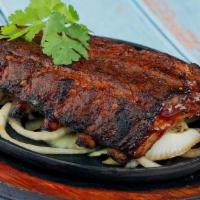 Baby Back Ribs · Baby back ribs covered with delicious BBQ sauce.