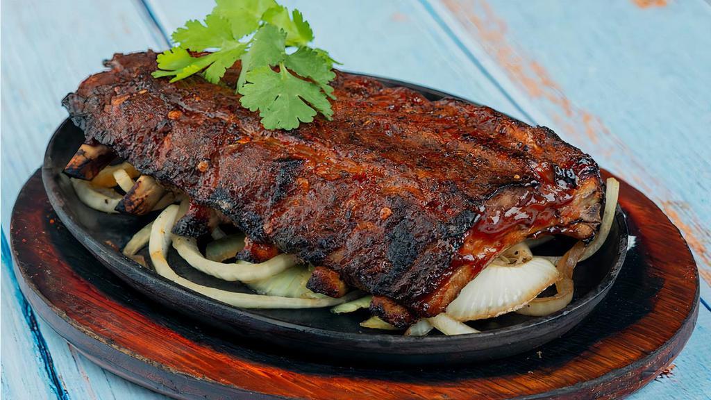 Baby Back Ribs · Baby back ribs covered with delicious BBQ sauce.