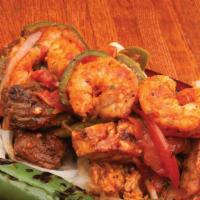 Fajitas Mariachi · Shrimp, beef, and chicken fajitas sautéed with onions, tomatoes, jalapeños, and bell peppers.