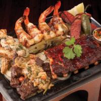Parrillada · Beef and chicken fajitas, BBQ ribs, sausage, and bacon wrapped shrimp. Served with queso wit...