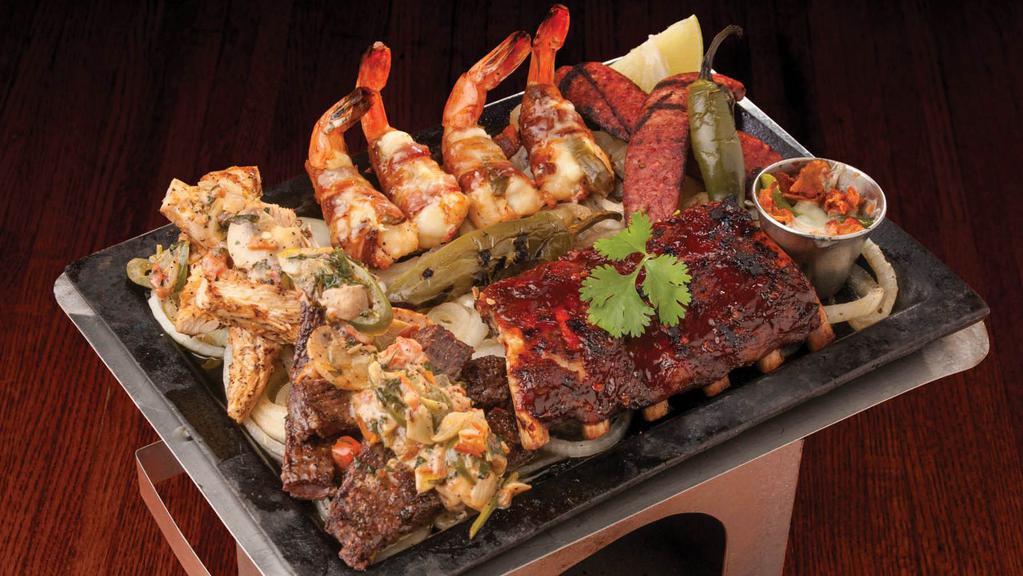 Parrillada · Beef and chicken fajitas, BBQ ribs, sausage, and bacon wrapped shrimp. Served with Los Cucos sauce and queso with bacon and poblano pepper.