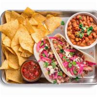 Cowboy Brisket Taco Plate · Two tacos (1 flavor) containing spicy brisket, pickled red onions, and salsa picante. Served...