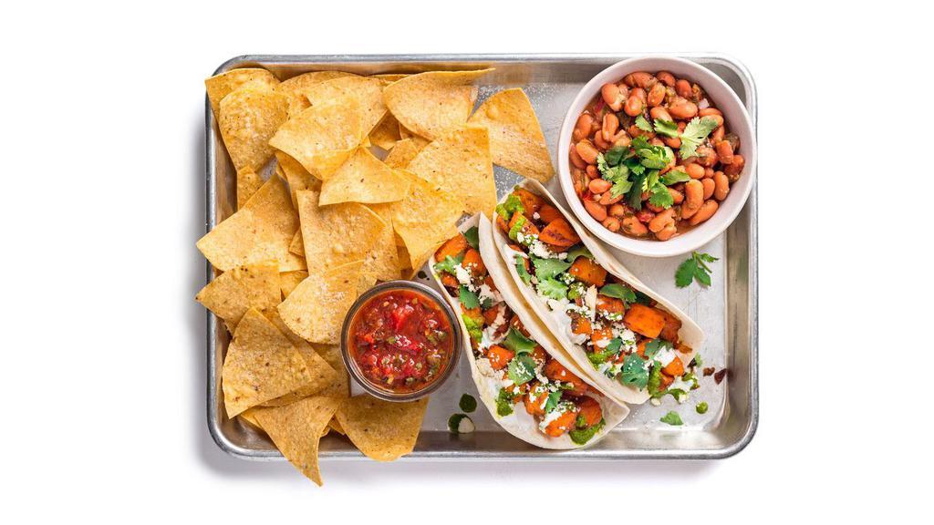 Sweet Potato Taco Plate · Two tacos (1 flavor) containing roasted sweet potato, aji verde, and crema. Served with ranchero beans and chips & salsa.