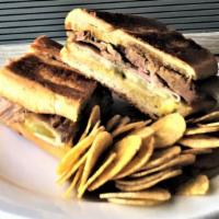 Hot Pressed Authentic Pork Cuban Sandwich · Premium ham, slow-roasted pork, dill pickles, Swiss cheese and yellow mustard.