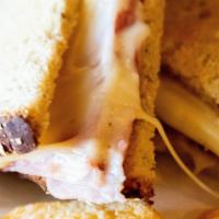 Grilled Cheese & Ham Sandwich · Premium American cheese and ham hot pressed in sourdough bread.