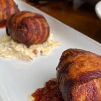 Big Daddy'S Trio · Three meatloaf balls wrapped in bacon stuffed with gouda cheese. Served over a bed of meatlo...