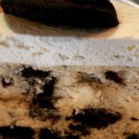 Oreo Cheesecake  · Layers of moist chocolate cake with cookies and cream filling between each layer topped with...