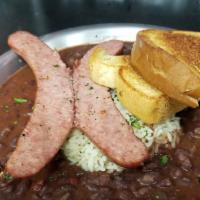 Nola Red Beans & Rice · Red beans, smoked sausage, white rice and garlic bread.