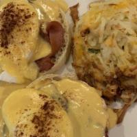 Egg Benedict · Two toasted English muffin halves, topped with smoked ham, two poached eggs, and authentic h...