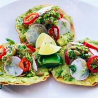 Tuna Tostadas · ahi tuna, jalapeño – cilantro pesto, lime, smashed avocado, shaved radish & fresno chiles on...