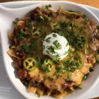 Bison Chili Frito Pie · bison chili, over fritos with shredded cheddar, sour cream, pickled jalapeños & green onion