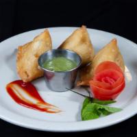 Samosa - 3 Pieces · Flaky pastry puff sheets stuffed with potatoes, peas and fried. Served with mint and tamarin...