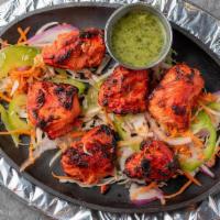 Chicken Tikka (Tandoor) · Boneless chicken marinated in yogurt and Indian masala cooked in tandoori oven. Served with ...