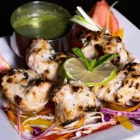 Chicken Malai Kebab · Juicy chicken marinated with mild creamy spices and cooked on a skewer in tandoori oven. Ser...