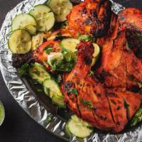 Tandoori Chicken · Tender marinated chicken grilled in tandoori oven with house spices. Served with mint chutne...
