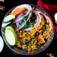 Chicken Biryani · Basmati rice flavored with exotic Indian spices and layered with Chicken. Served with raita ...