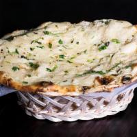 Garlic Naan · Flat fluffy bread cooked in tandoor oven is topped with minced garlic.