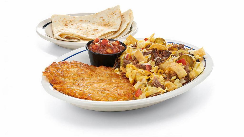 Machaca · Scrambled eggs with shredded beef, Jack & Cheddar, onions, jalapenos, tomatoes & tortilla strips. Served with hash browns, tortillas & our salsa.