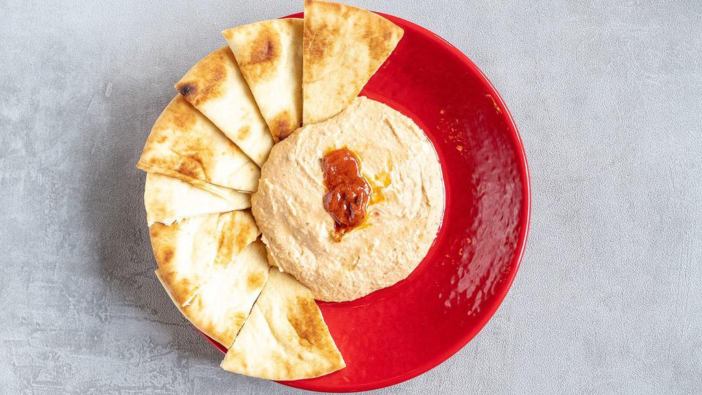 Spicy Hummus · Classic Hummus kicked up a notch with the spice of Harissa. Paired with pita.