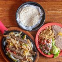 Fajitas (For 1) · Grilled with peppers and onions served sizzling with guacamole, pico, sour cream, and tortil...