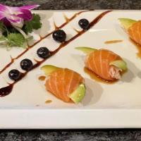 Butterfly Kiss (5) · Raw. Salmon, crabmeat mix, avocado rolled, topped with masago, ponzu, and sumo sauce.