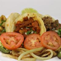 Tacos Plate · Three Mexican tacos served with corn tortillas, grilled onions, tomatoes, and a jalapeño.